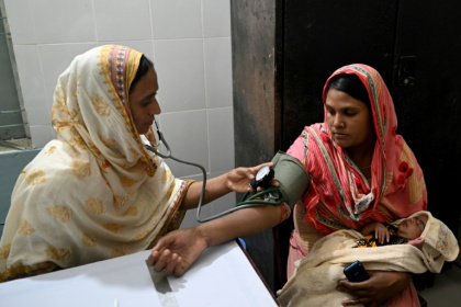 Nargis Akhter (left) is one of thousands of Bangladeshi women working as "skilled birth attendants" to help mothers through delivery