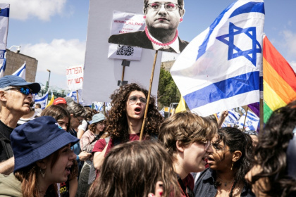 People wave flags during a protest against Israel's Prime Minister Benjamin Netanyahu, in Jerusalem on March 19, 2025
