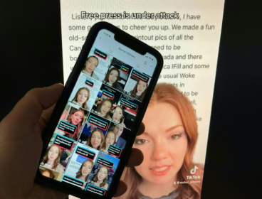 Photo illustration created December 15, 2022, in Washington, DC, shows a person holding up the TikTok feed of Canadian journalist Rachel Gilmore against the backdrop of one of her online posts.