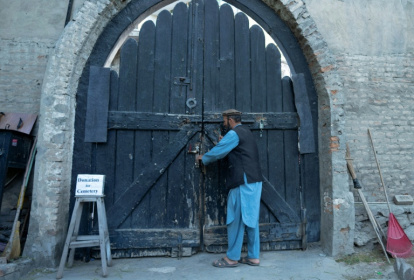 Gravekeeper Aynullah Rahimi unlocks a door at the British Cemetery in the Sherpur neighbourhood of Kabul, home to generations of foreign fighters, explorers and devotees of Afghanistan - Wakil KOHSAR (AFP)