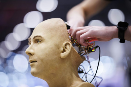 A man works on the electronics of Jules, a humanoid robot from Hanson Robotics using AI, at the recent International Telecommunication Union AI for Good Global Summit in Geneva - Valentin FLAURAUD (AFP)
