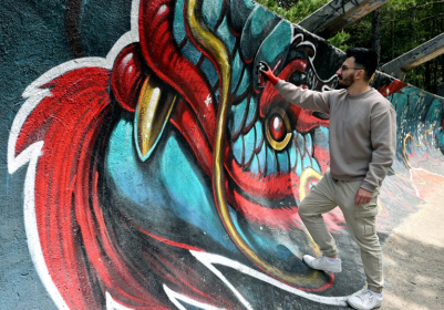 Street artist Kerim Musanovic puts the finishing touches to touches to a painting on the former Olympic bobsled track at Mount Trebevic, near Sarajevo - ELVIS BARUKCIC (AFP)