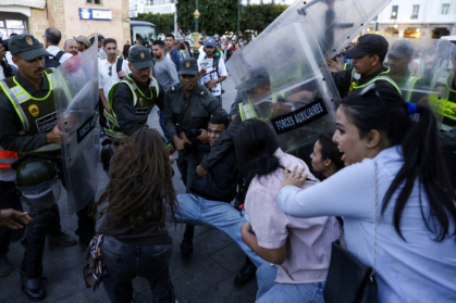 Members of the security forces detain a protester as others scuffle during a demonstration in Rabat, calling for reforms in the public health and education sectors - Abdel Majid BZIOUAT (AFP)