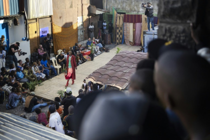 Models show off outfits created by local fashion designers specialising in upcycling discarded fabrics and garments from second-hand clothes markets - Tony KARUMBA (AFP)