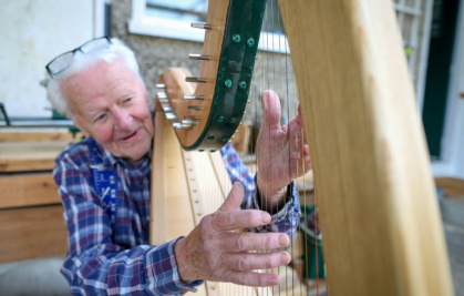 'It's never too late to start a new hobby,' says 89-year-old Irish harp maker Noel Anderson, who has been making harps for the best seven years - Paul Faith (AFP)