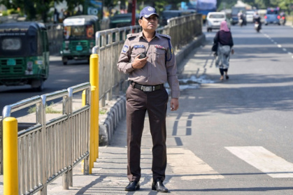 A Bangladesh police officer wears the new grey and brown uniform in Dhaka, but critics doubt whether the change in colours will mend the force's shattered reputation - Munir UZ ZAMAN (AFP)