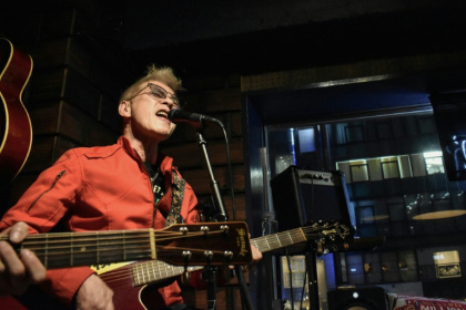 Lawyer Akihiro Shima, who spearheads a landmark climate change lawsuit in Japan, singing at a bar in Tokyo's Ginza district - Tomohiro OSAKI (AFP)