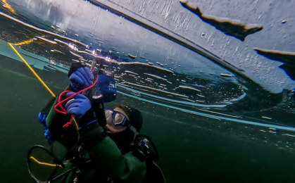 A participant in the Polar Scientific Diving programme takes ice samples during a 45-minute-long diving session - -STR (AFP)
