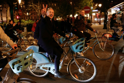 Socialist candidate Emmanuel Gregoire hopped on one of Paris's iconic rental bikes to head to city hall - Kenzo TRIBOUILLARD (AFP)