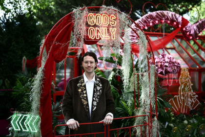 Designer James Whiting poses at his exhibit 'Aphrodite's Hothouse' billed as 'lush, fragrant and just a little bit naughty' at the 2026 RHS Chelsea Flower Show in London - Henry Nicholls (AFP)