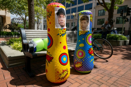Inflatable punching bags with added pictures of Elon Musk and Sam Altman are seen outside the Ronald V. Dellums Federal Building and US Courthouse as the Musk v. Altman trial begins in Oakland, California in April 2026 - Karl Mondon (AFP)