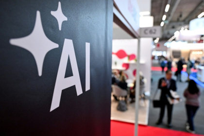 People walk past a banner for AI at the 2024 Frankfurt book fair - Kirill KUDRYAVTSEV (AFP)