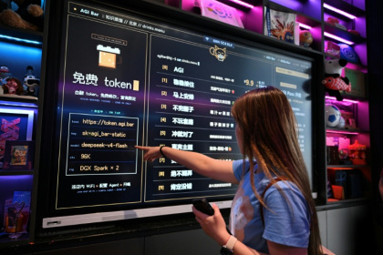 A customer looks at a board with the menu at AGI Bar in Beijing's in Zhongguancun district on August 9, 2026. - Pedro PARDO (AFP)